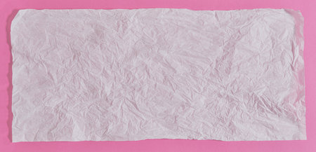 White empty paper sheet for text on pink background. close up
