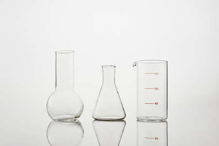 Collection of chemical glassware in laboratory on a white background. Test tubes and laboratory glassware for experiments.の写真素材