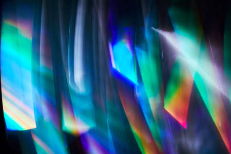 Light painting one exposure in camera. light glares with a spectral gradient on a dark background....