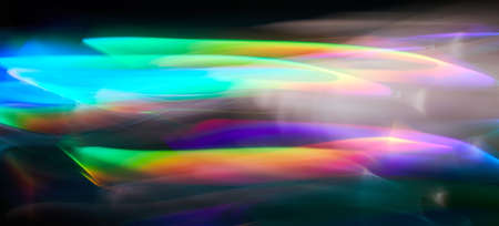 Light painting one exposure in camera. light glares with a spectral gradient on a dark background....