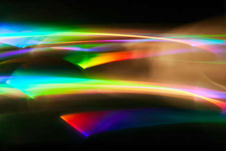 Light painting one exposure in camera. light glares with a spectral gradient on a dark background....