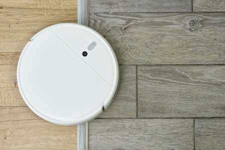 Robot vacuum cleaner drives on different surfaces. Overcoming doorstep with robot vacuum cleaner....