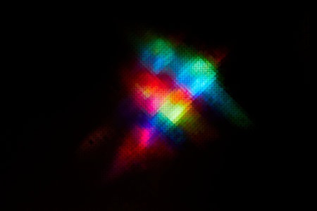 Blurred Glow Effect. Defocused rainbow colorful light on dark abstract background. Defocused Light...