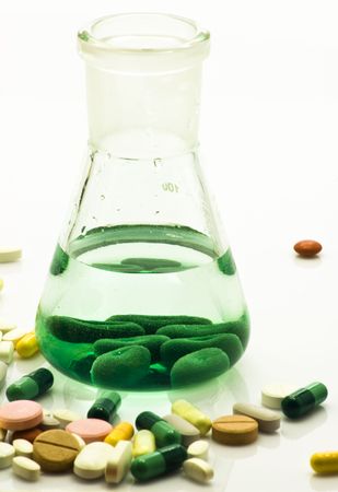 Pills in the liquid and on the tableの写真素材