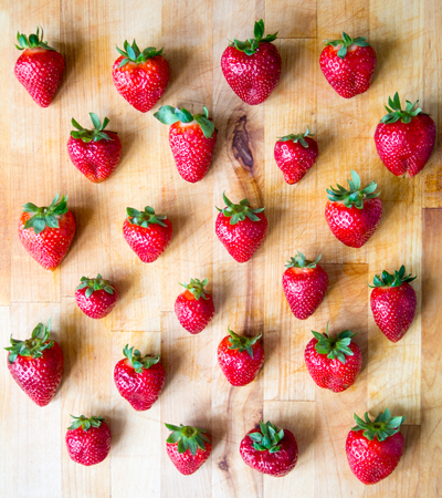 Arranged strawberries on a wooden boardの写真素材
