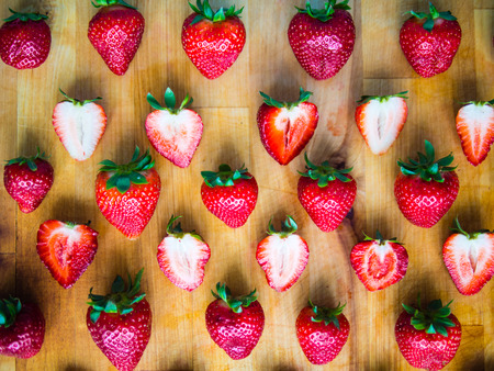 Arranged fresh strawberries on a wooden boardの写真素材