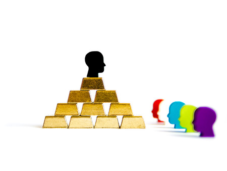 Golden bricks: wealth inequality conceptualisation isolated with tokensの写真素材