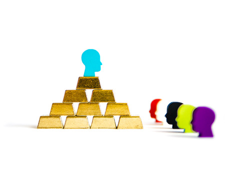 Golden bricks: wealth inequality conceptualisation isolated with tokensの写真素材
