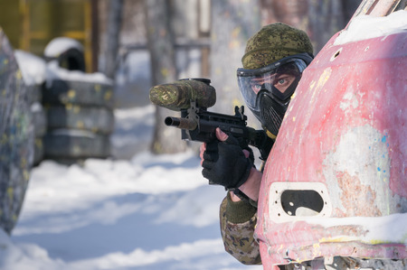 A man with a paintball marker is played on the fieldの写真素材