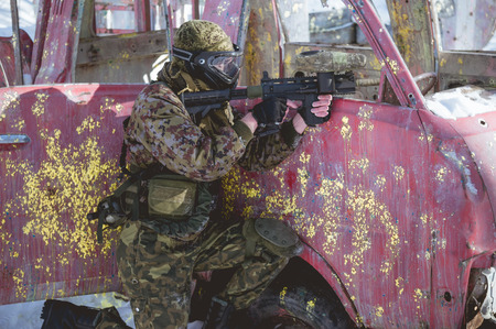 A man with a paintball marker is played on the field