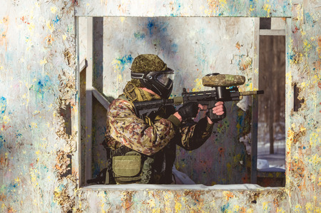 A man with a paintball marker is played on the field