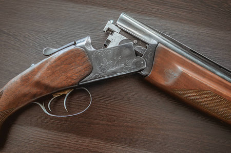 Hunting rifle on a wooden background