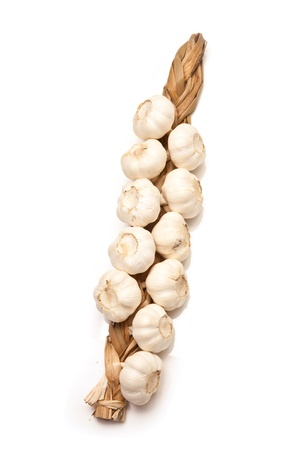 String of garlic bulbs isolated on a white studio background.の写真素材