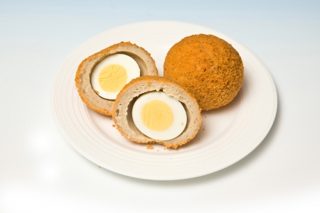 Scotch eggs on a blue studio backgroundの写真素材