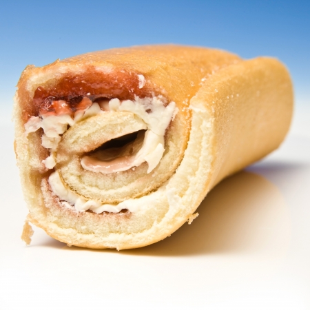 Swiss roll on a graduated blue studio background.の写真素材