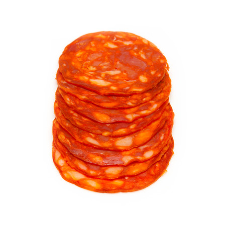 Sliced Spanish chorizo sausage isolated on a white studio.の写真素材