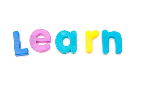 Learn written in magnetic letters. on a white studio background.の写真素材