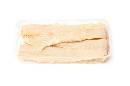 Pieces of salt cod fish isolated on a white studio background.
