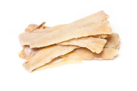 Pieces of salt cod fish isolated on a white studio background.