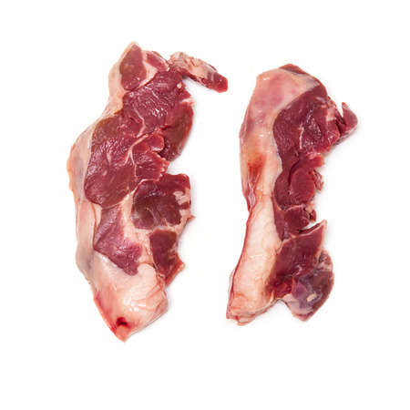 Uncooked goat meat leg steaks isolated on a white studio background.の写真素材