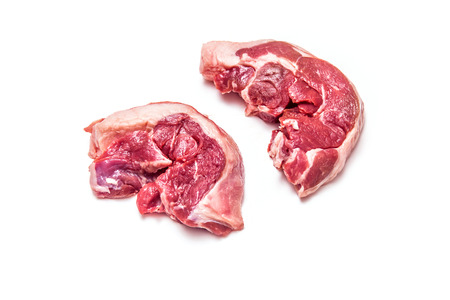 Uncooked goat meat leg steaks isolated on a white studio background.の写真素材