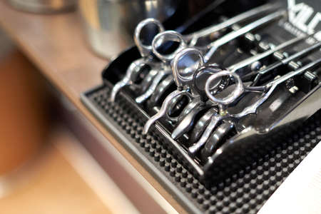 Collection of scissors in a dispenser in a barber shop
