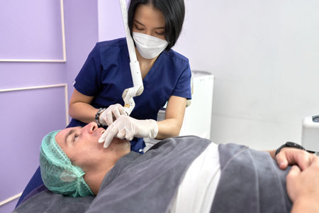 Profile of a patient receiving a beauty treatment with laser in a clinic