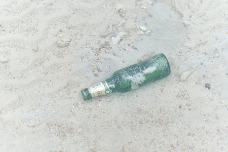 Close up and top view of a bottle of beer floating under the seaの写真素材