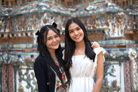Portrait of two asian friends looking at camera in a temple in Thailandの写真素材