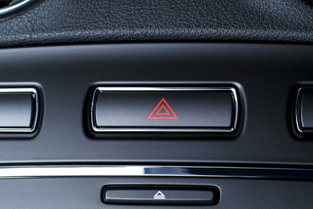 Button of vehicle, car hazard warning flashers button with visible red triangle, visible  fragment...