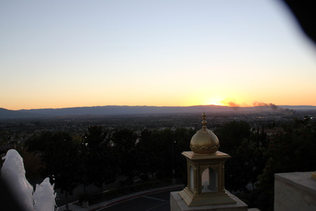 Sunset view of San Jose city, California from near Sikh Gurdwara on hill, with golden sky and haze just above the horizon.の写真素材