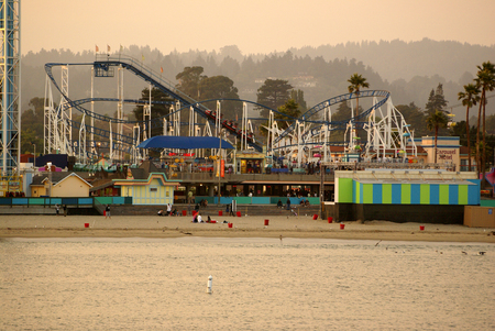 Santa Cruz Bay area in California, USA, thronged by visitors with parked boats and ships, majestic buildings, rows of palms and play areas.のeditorial素材