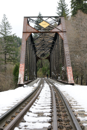 Snow covered railway track leading to Mossbrae falls in Dunsmuir, California, beautiful waterfalls in Shasta Cascade area flow into Sacramento river. Walking on rail track prohibited from 2011.の写真素材