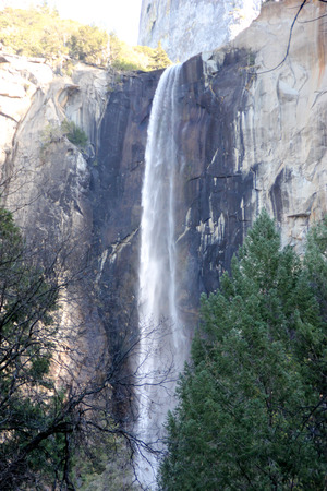 Bridalveil Fall, Yosemite National Park, California, view from Parking lot with Cathedral rock above,  189 m high waterfall with light swaying flow on November 23, thickest and thundering in springの写真素材