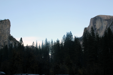 View of Half Dome on right and Washington column plus North Dome on left with dip in between with crowns of conifer trees, from Curry Village Half Dome Parking.の写真素材