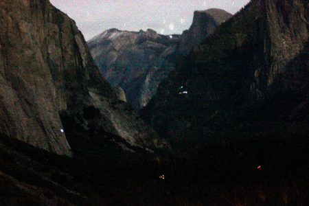Early night view of peaks from Tunnel view, Yosemite National Park, California, with traffic lights, camping sites and mountaineers climbing on rocks mainly El Capitan on left.の写真素材
