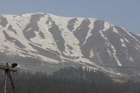 Apharwat Mountain slopes seen from Gulmarg, Kashmir, snowing melting from lower slopes, a favorite tourist destination.の写真素材