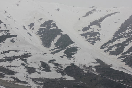 Apharwat Mountain slopes seen from Gulmarg, Kashmir, snowing melting from lower slopes, a favorite tourist destination.の写真素材