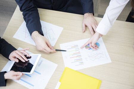 Hands of three men and women meeting in a meeting room