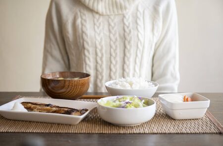Hand of young woman eating breakfastの写真素材