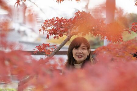 Young woman enjoying autumn leaves huntingの写真素材