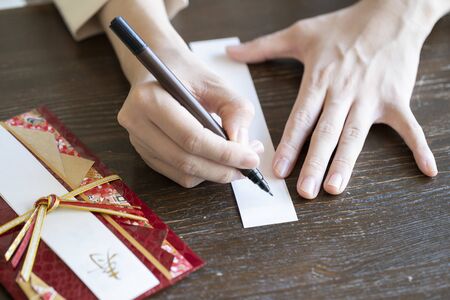 Young woman hand writing congratulation bagの写真素材