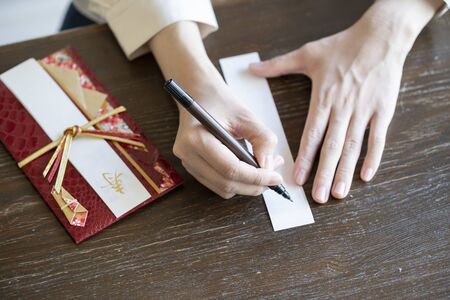 Young woman hand writing congratulation bagの写真素材