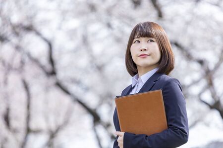 Woman in suit and cherry blossomの写真素材