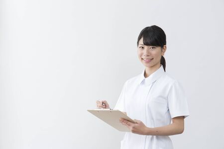 Woman in white coatの写真素材