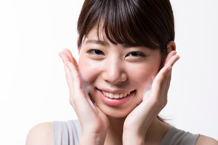 Beauty image of young Japan woman washing her faceの写真素材