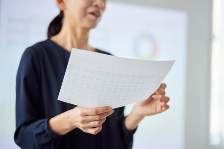 Japan senior woman giving a presentation in officeの写真素材