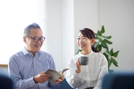 Japan senior couple relaxing in the living roomの写真素材