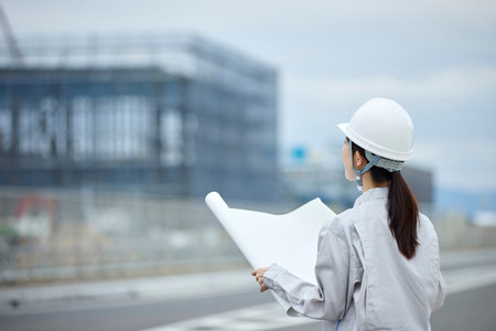 Construction site and woman in work clothes