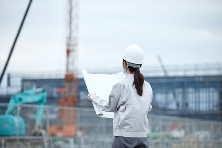 Construction site and woman in work clothes